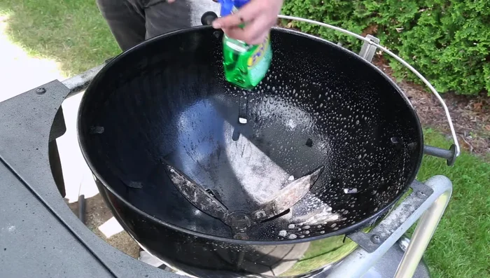 Spray the lid and grill grate with degreaser. Scrub thoroughly using steel wool.