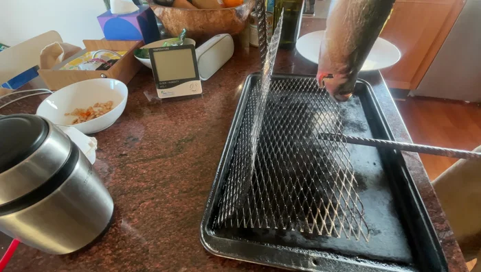 Grill the mackerel, oiling it occasionally to maintain moisture and achieve crispy skin. Flip it once the underside is cooked (less than a minute).