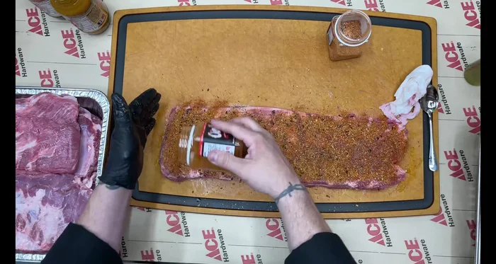 Season the ribs: Apply olive oil as a binder, then generously coat the ribs with Oink and Rub-a-dub rubs on both sides.