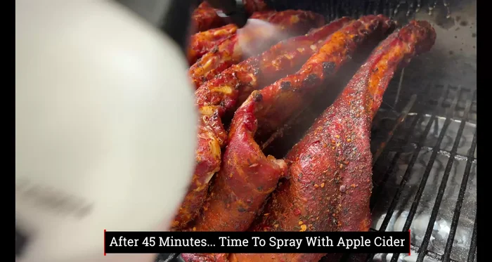 First spritz: After 45 minutes, spritz the ribs with apple cider and separate them if needed.