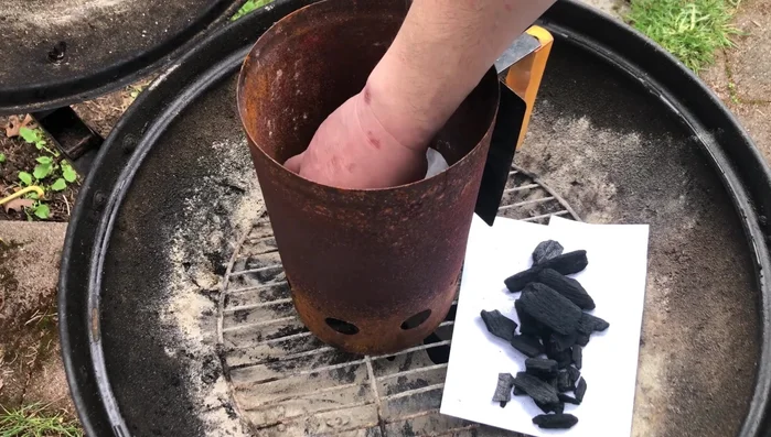 Layer the charcoal: Add a layer of easily ignitable lump charcoal at the bottom, followed by briquettes on top.