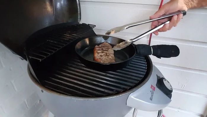 Add butter, fresh thyme, and garlic to the skillet; baste the steak with the melted butter mixture for a couple of minutes.