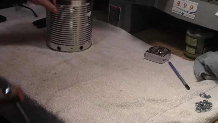 Mark the can to receive the handle and drill holes for the bolts.