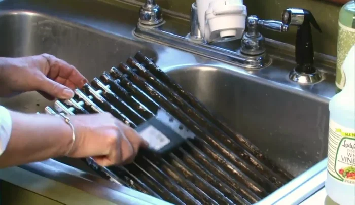 Use a metal brush to scrub off as much grime as possible. You can even do this on the grill itself, using the heat to melt grease.