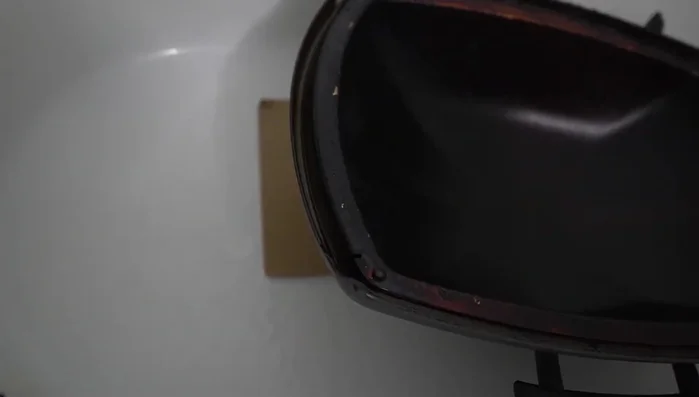 Scrub the grill components with a sponge.