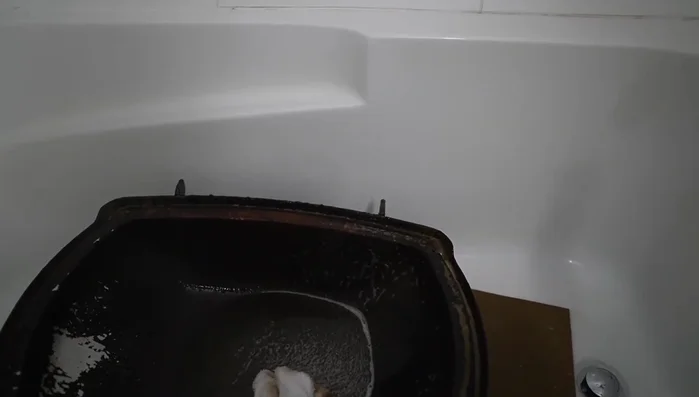 Scrub the grill components with a sponge.