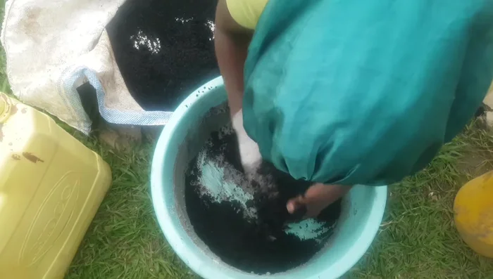 Add the sifted charcoal dust to the ash paste and mix thoroughly until a stiff, moldable consistency is achieved.