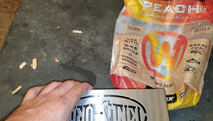 Prepare the gas grill for smoking: Place wood chips on top of a burner to create smoke.