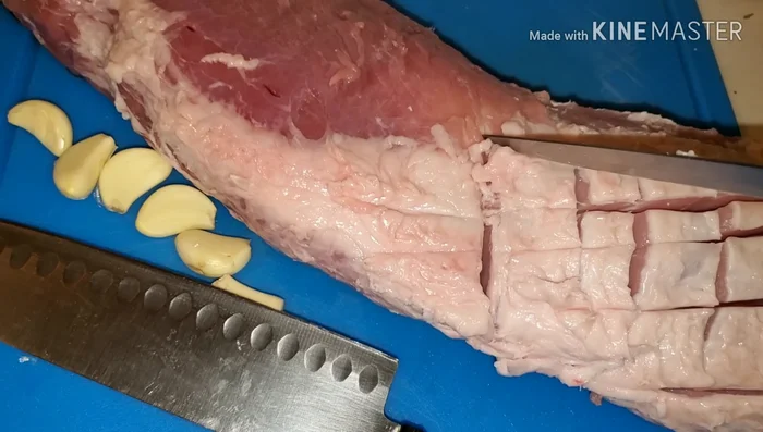 Prepare the pork loin: Trim excess fat and poke holes for garlic insertion.