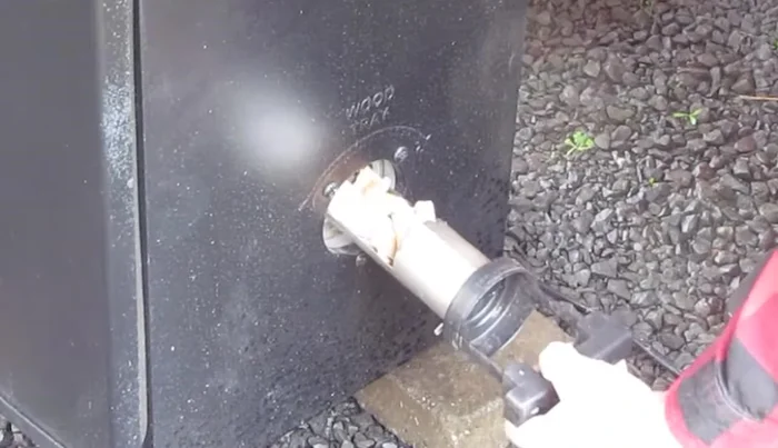 Insert the loading tube into the smoker, turning it clockwise to lock it in place. 