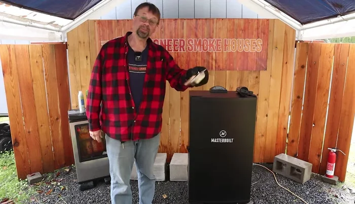 Locate the wood chip pan in your Masterbuilt electric smoker. It's small but fits perfectly inside.