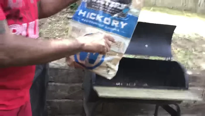 Prepare the grill and add hickory chunks: Once the coals are ready, place the grill over them. Add hickory wood chunks for extra flavor.