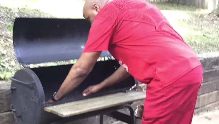 Soak the coals with lighter fluid: Generously apply lighter fluid to the coals, ensuring most of them are soaked. Let it soak for 5-10 minutes.