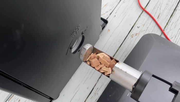 Open the smoker's wood chip tray.