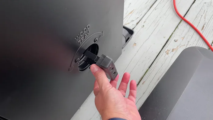 Rotate the tray to distribute the chips into the smoker box. This will release the chips into the smoker chamber.