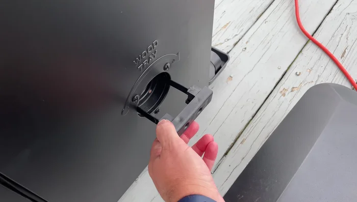 Rotate the tray to distribute the chips into the smoker box. This will release the chips into the smoker chamber.