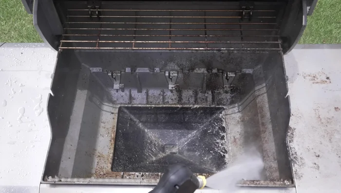 Use a pressure washer to remove large debris from the grill components.