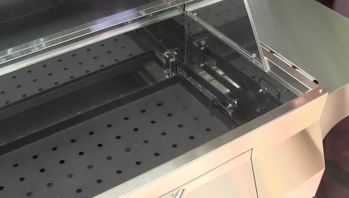 Adjustable charcoal tray with six height settings.