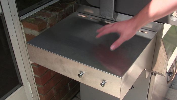 Stainless steel grill side table with ample workspace.