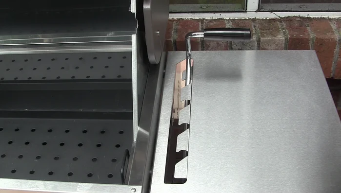 Grill's adjustable charcoal tray height