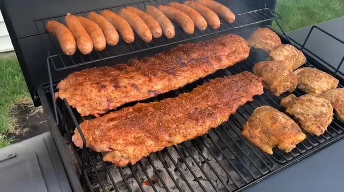 Royal Gourmet grill cooking ribs, chicken, and sausage.