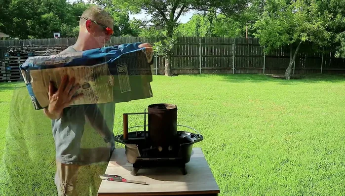 Man using chimney starter for charcoal grill