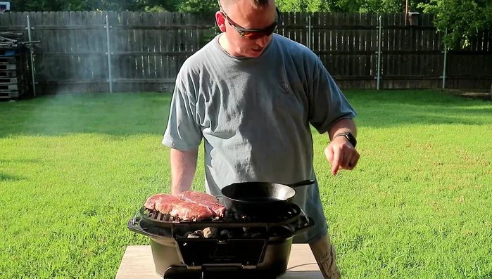 Cast iron grill cooking steaks and radish chips.