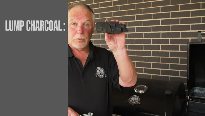 Man holding lump charcoal for grilling
