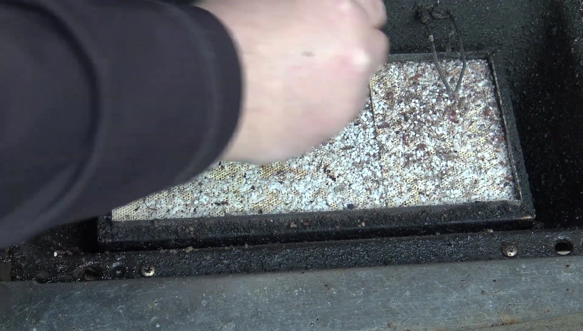Cleaning a Napoleon grill sizzle zone burner.