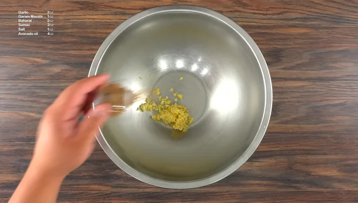 Prepare a simple side dish: Sauté red onions with avocado oil, sumac, salt, and baharat until caramelized.