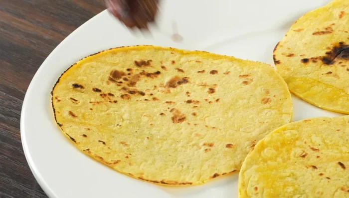 Assemble tacos: Fill tortillas with steak, cilantro, onions, and salsa.