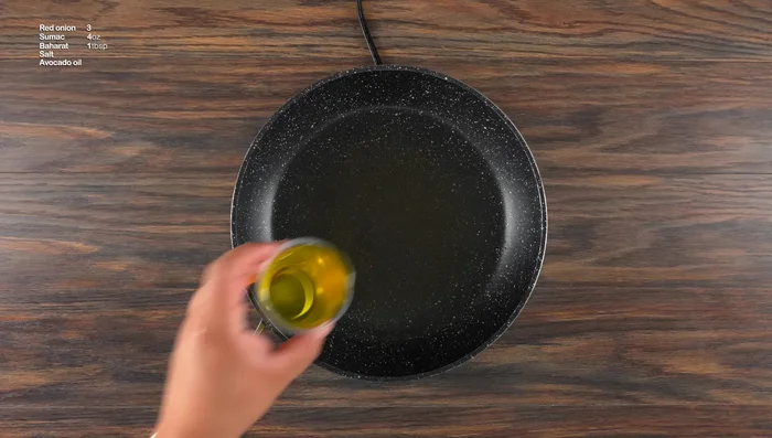 Prepare a simple side dish: Sauté red onions with avocado oil, sumac, salt, and baharat until caramelized.