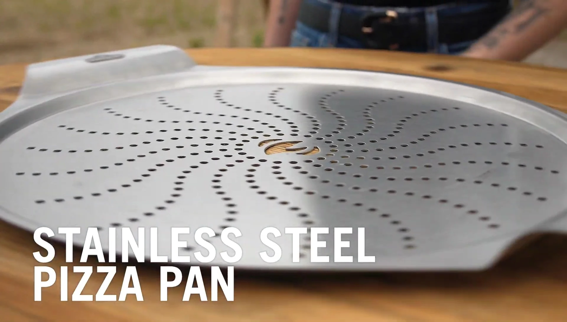 Close-up view highlighting the holes in the bottom of the pizza pan.