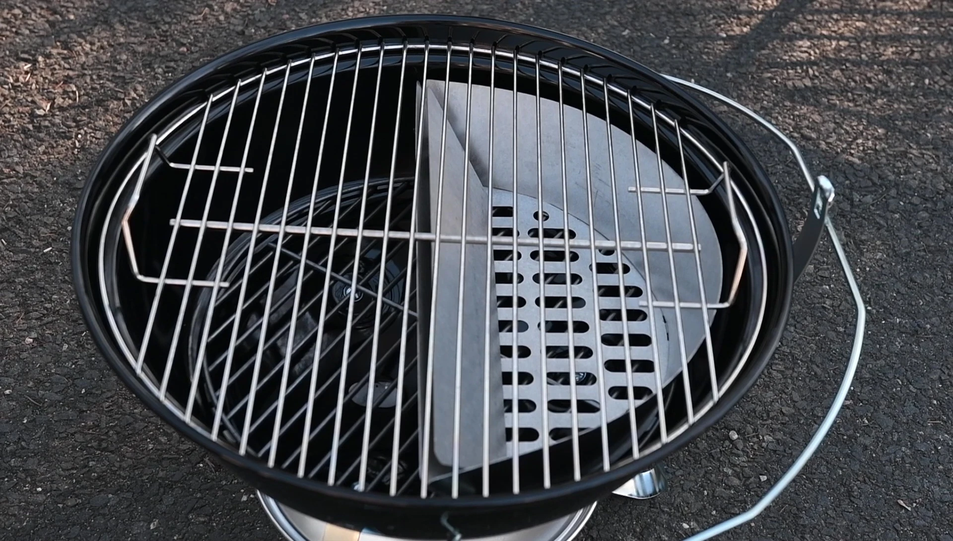 Size comparison between the Slow 'N Sear and a standard Weber charcoal basket.