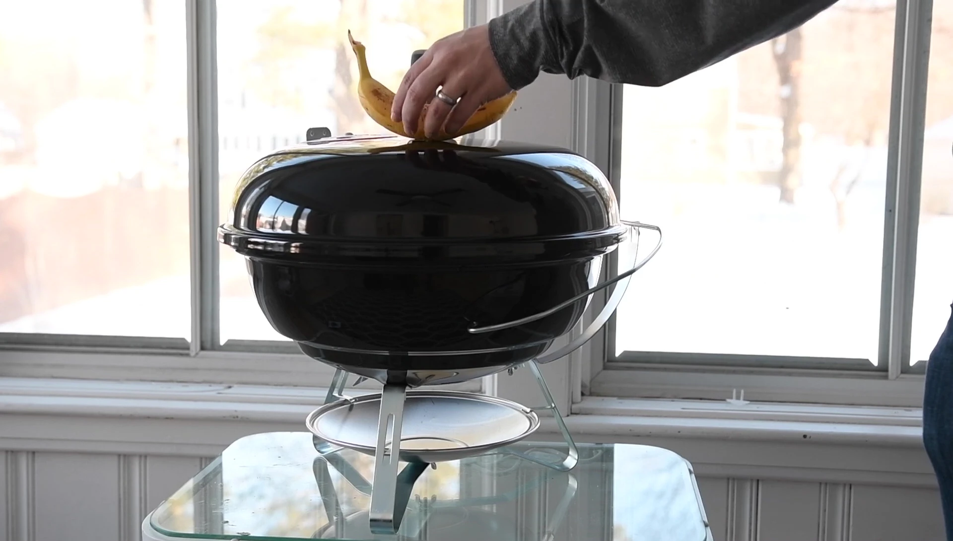 Size comparison of the Jumbo Joe with a banana, a Weber Summit, and a Weber Kettle.
