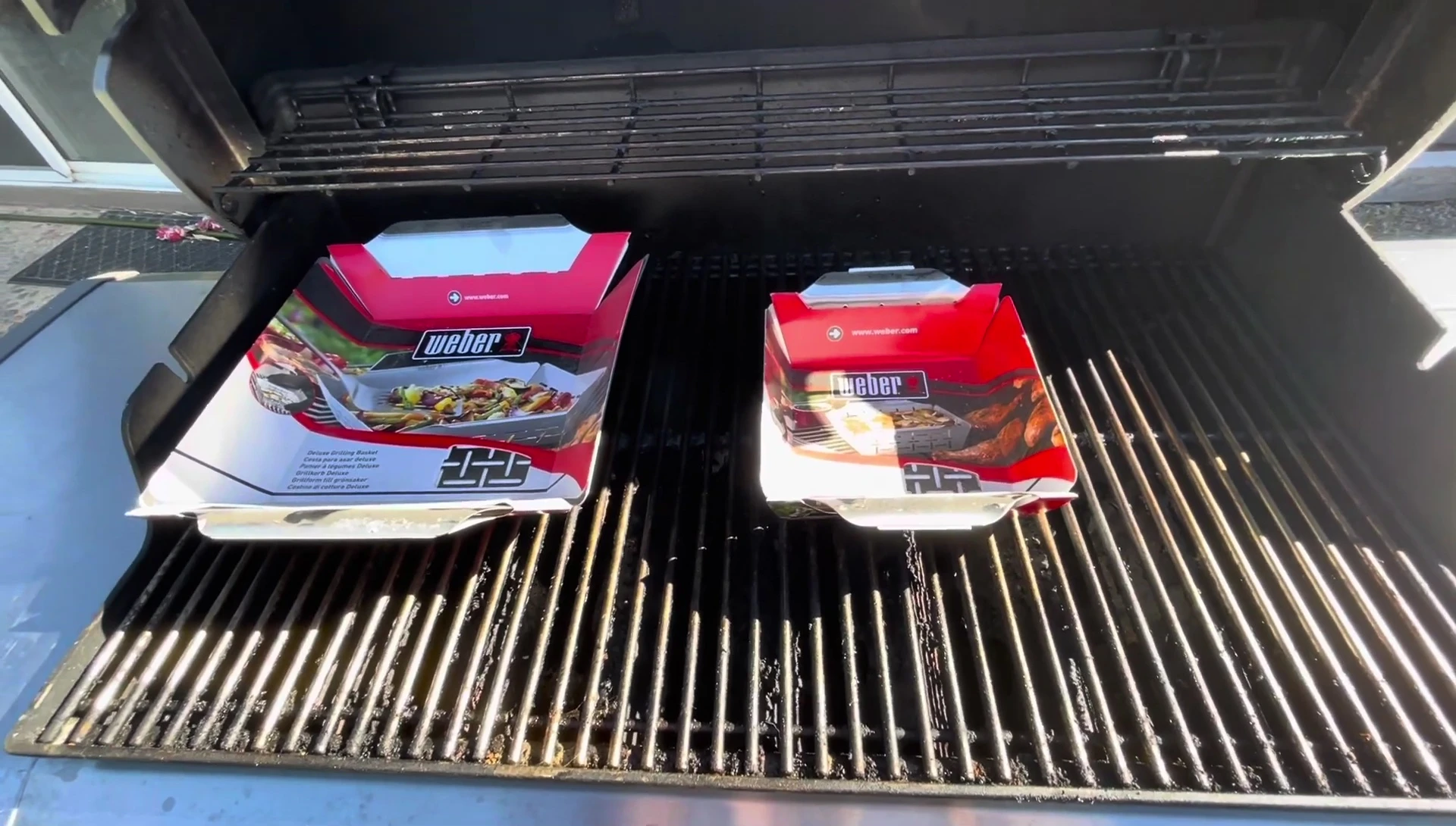 Two Weber grilling baskets on grill