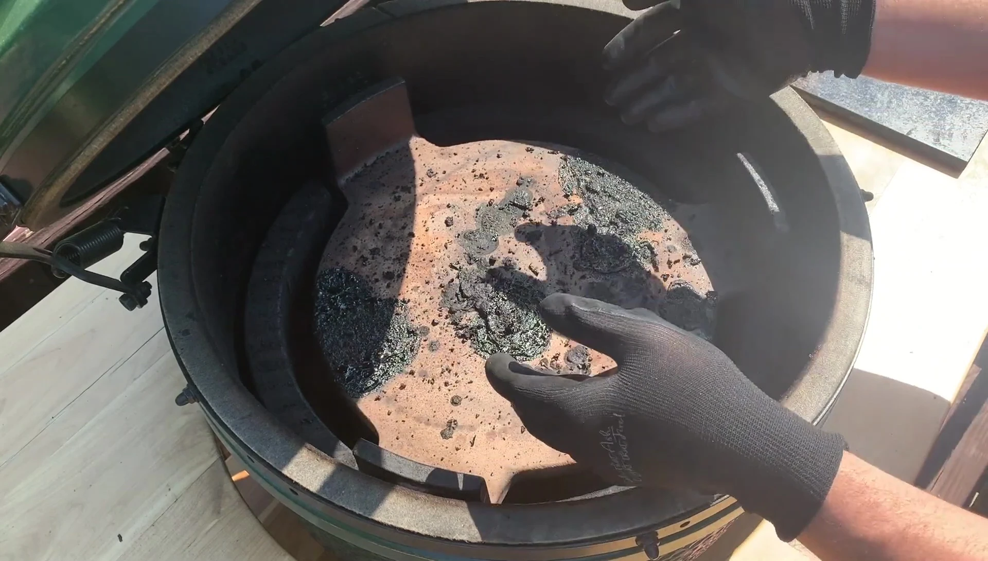 Cleaning a grill with Kick Ash gloves.