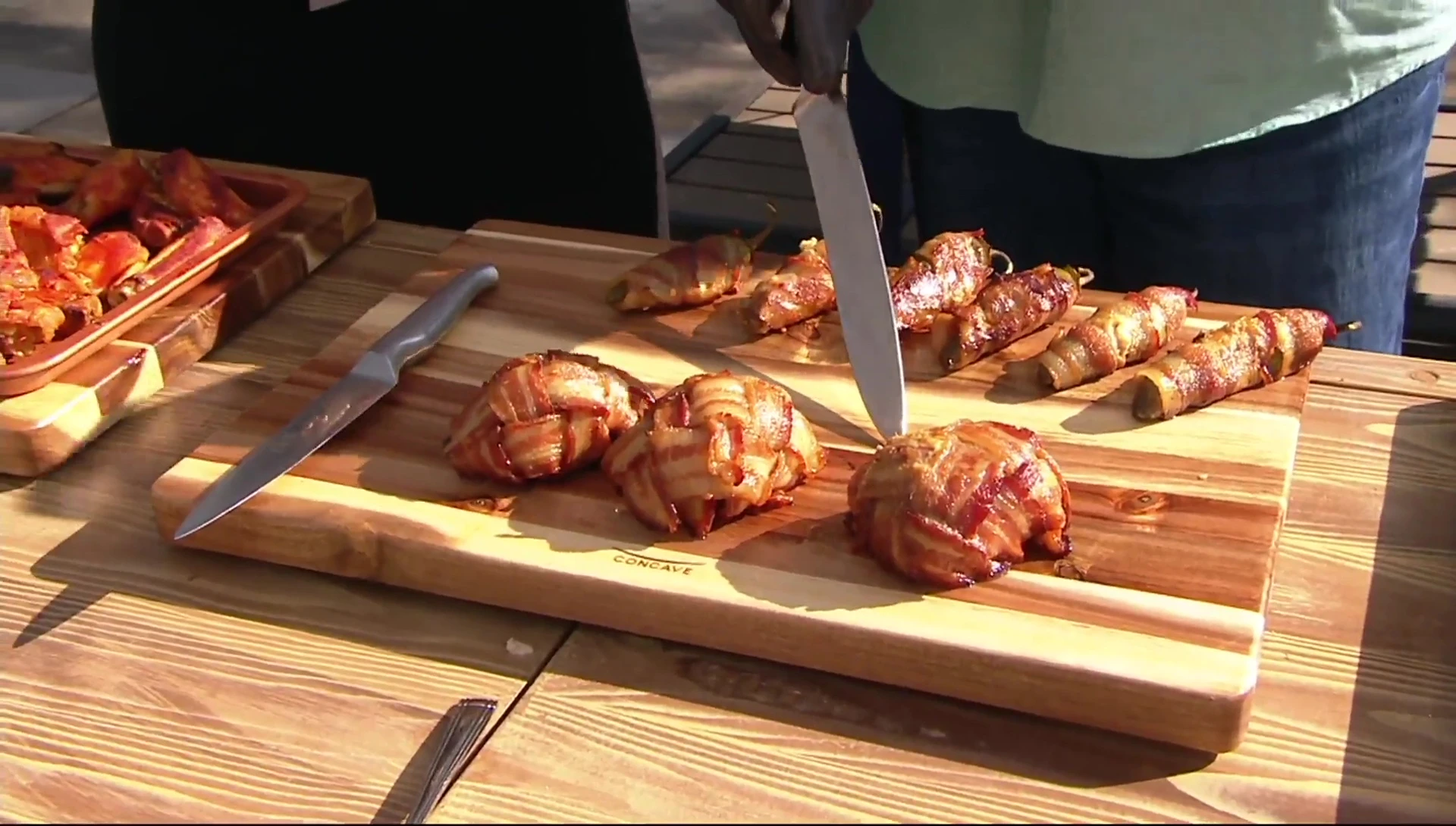 Bacon-wrapped food on cutting board