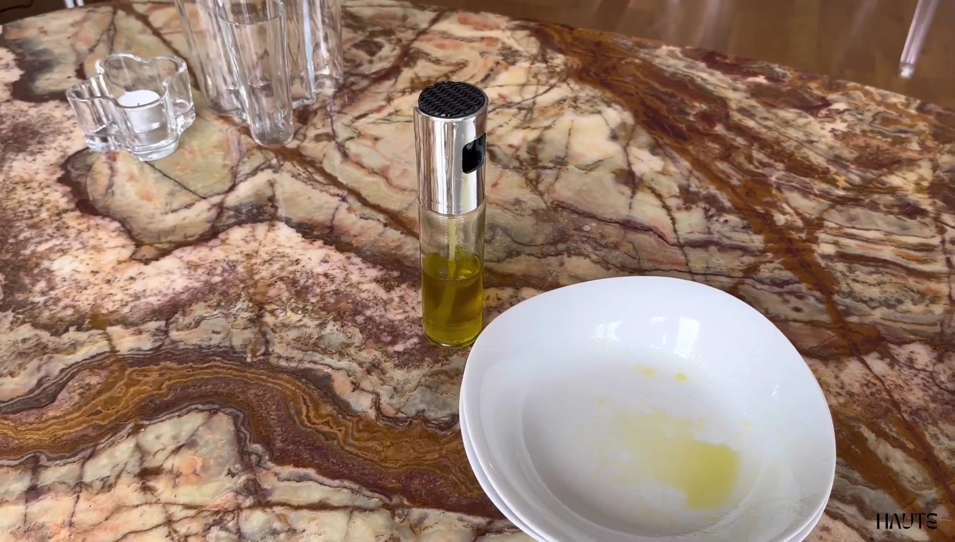 Olive oil sprayer bottle on table