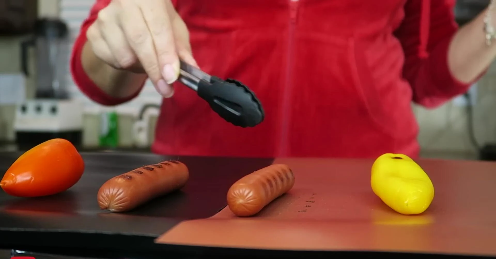 Hot dog mysteriously moves on cooking mat.