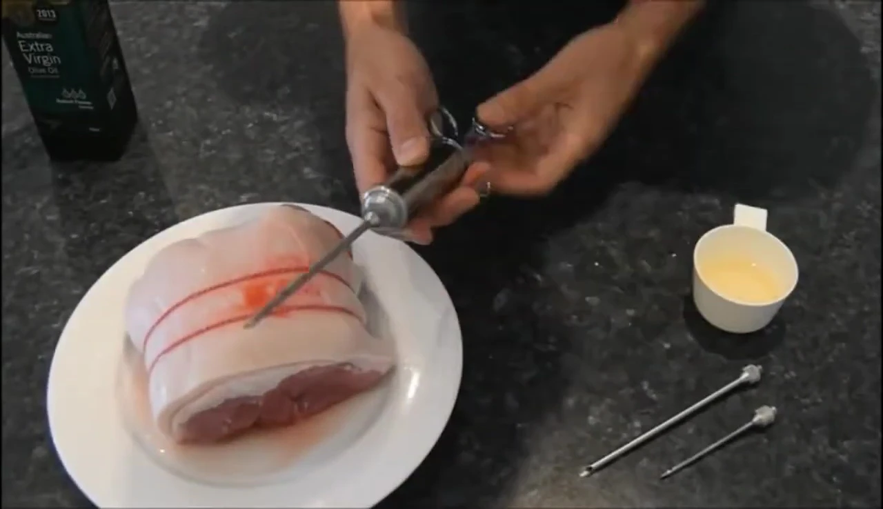 Injecting marinade into meat with needle