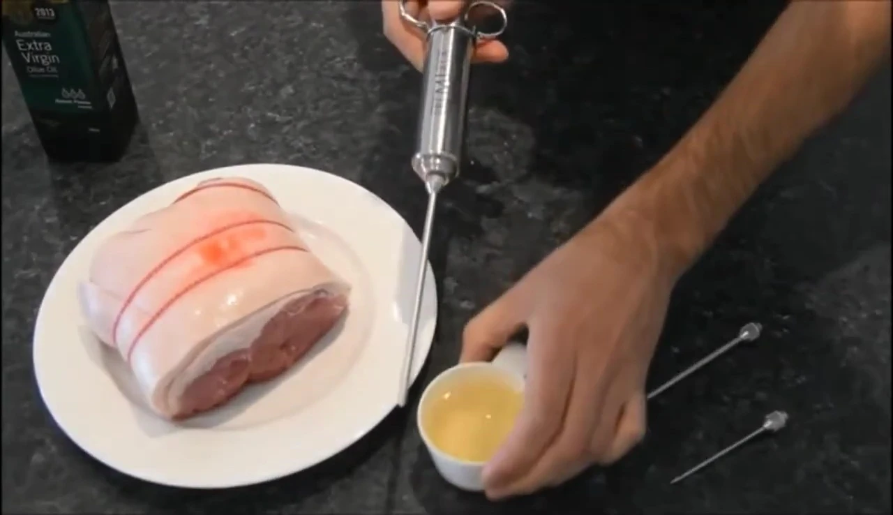 Meat injector with marinade and needles.
