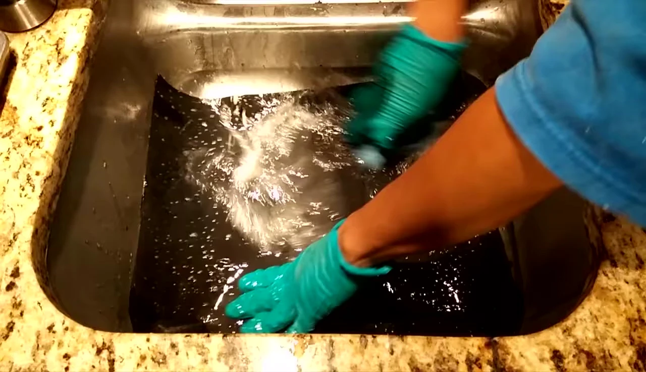 Demonstration of cleaning the mats with soap and water.