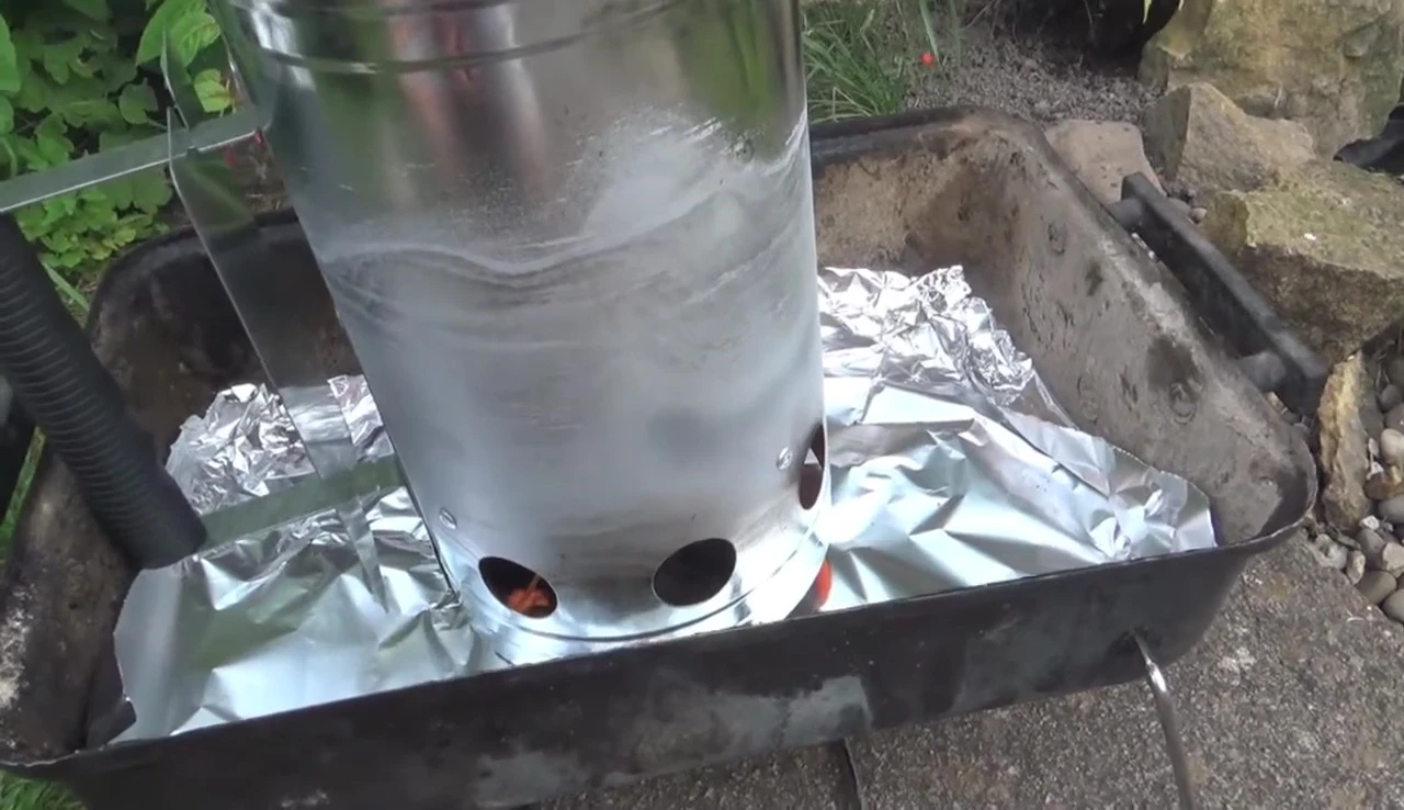 Windproof chimney starter igniting coals