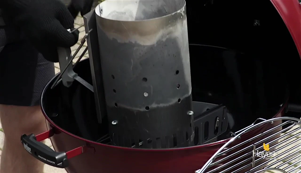 Removing coals from chimney starter.