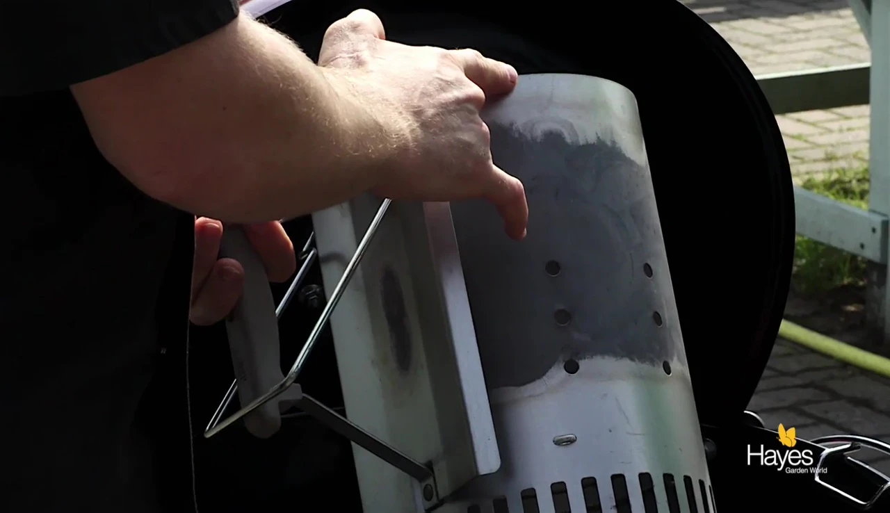 Chimney starter with charcoal briquettes