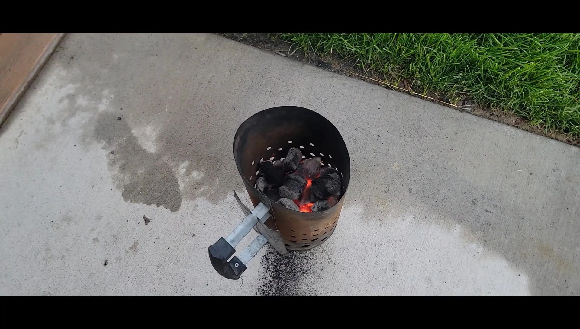 Charcoal chimney starter with briquettes