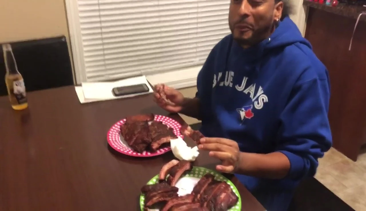 Man taste-testing BBQ ribs