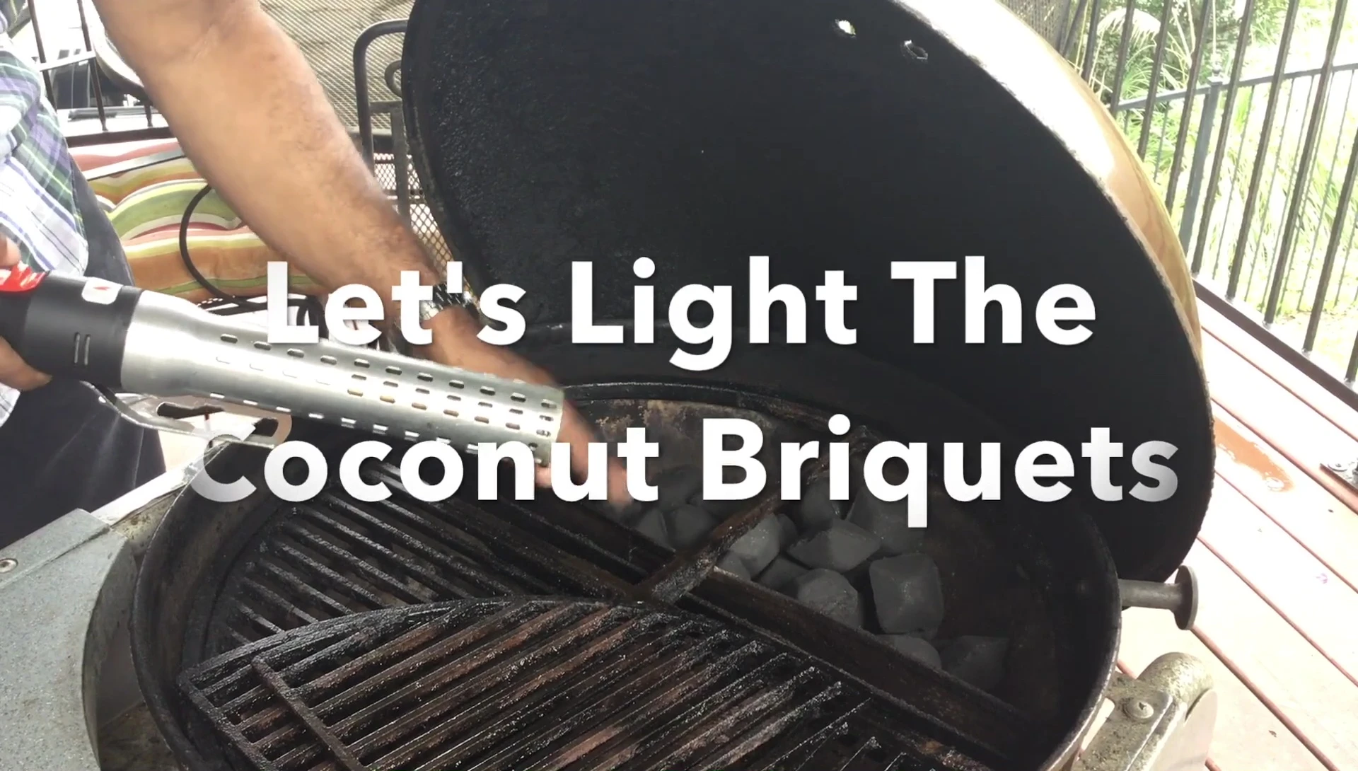 The reviewer attempts to light the coconut briquettes with a looped lighter.