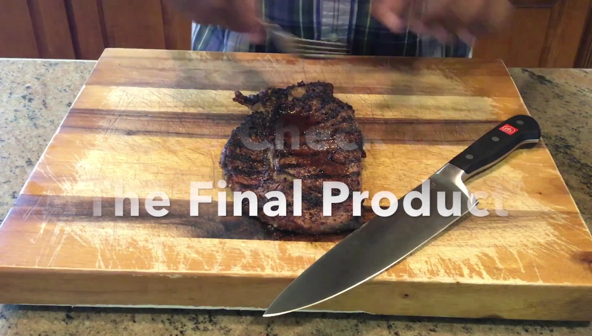 The cooked ribeye steak being cut open to reveal its doneness.
